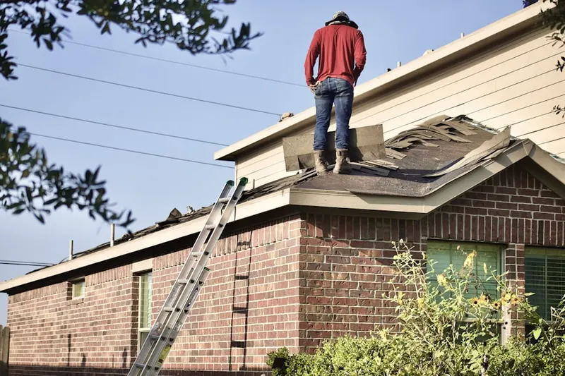 Professional roofer working on a residential roof in Pleasant Valley